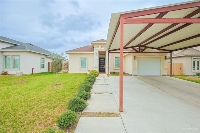 view of front of property with stucco siding, a garage, a front yard, fence, and a carport