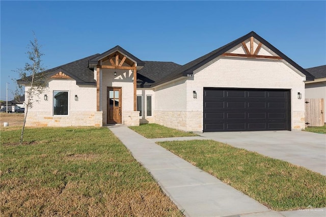 view of front of house with a front yard and a garage