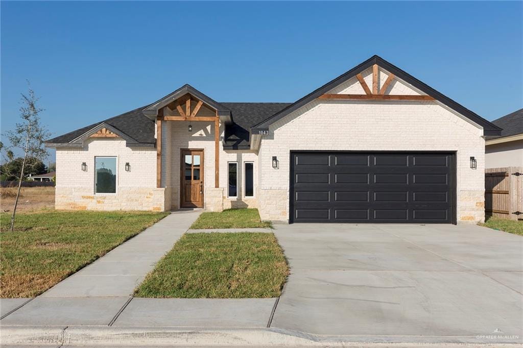 view of front of property with a garage and a front lawn