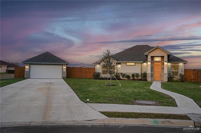 view of front of home featuring a garage and a yard