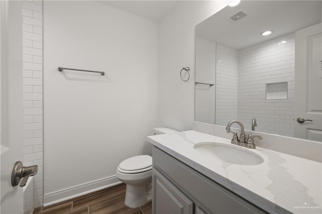 2206 Seagull Ln, Mission, TX 78572 - bathroom featuring toilet, visible vents, baseboards, wood finished floors, and vanity