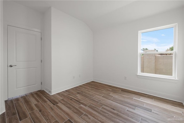 2206 Seagull Ln, Mission, TX 78572 - empty room with vaulted ceiling, baseboards, and wood finished floors