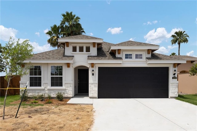 2206 Seagull Ln, Mission, TX 78572 - prairie-style home featuring a shingled roof, an attached garage, stone siding, and driveway