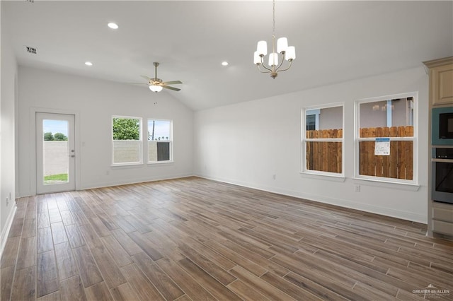 2206 Seagull Ln, Mission, TX 78572 - unfurnished living room with vaulted ceiling, wood finished floors, visible vents, baseboards, and ceiling fan with notable chandelier