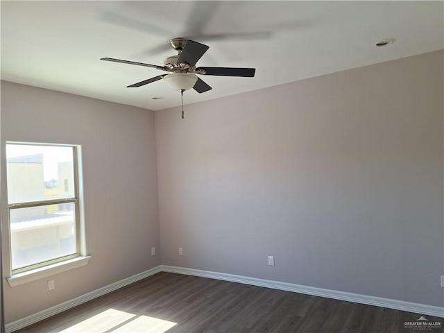 spare room featuring dark hardwood / wood-style floors and ceiling fan