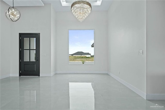 foyer entrance featuring a notable chandelier