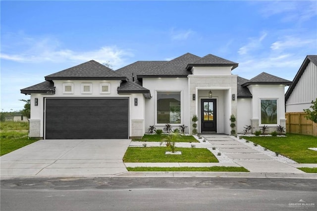 view of front of house featuring a front lawn and a garage