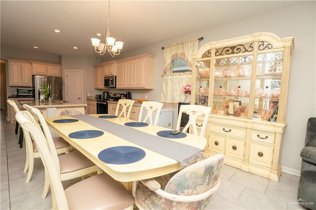 dining space with a chandelier, light tile patterned floors, and recessed lighting