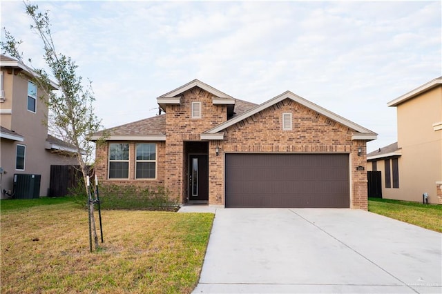 view of front of home with driveway, an attached garage, a front lawn, central AC, and brick siding