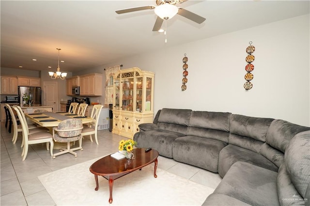 living room featuring ceiling fan with notable chandelier, light tile patterned flooring, and recessed lighting