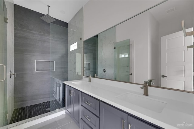 bathroom with walk in shower, vanity, and tile patterned flooring