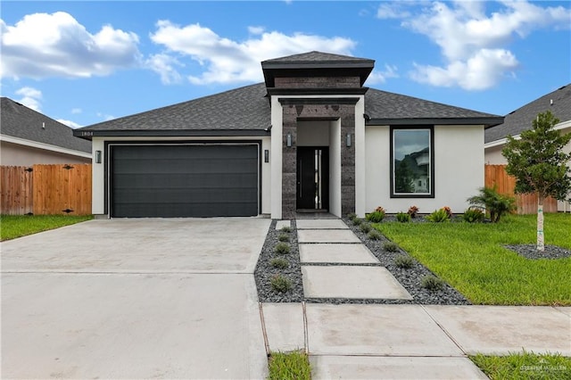 view of front of property with a front yard and a garage