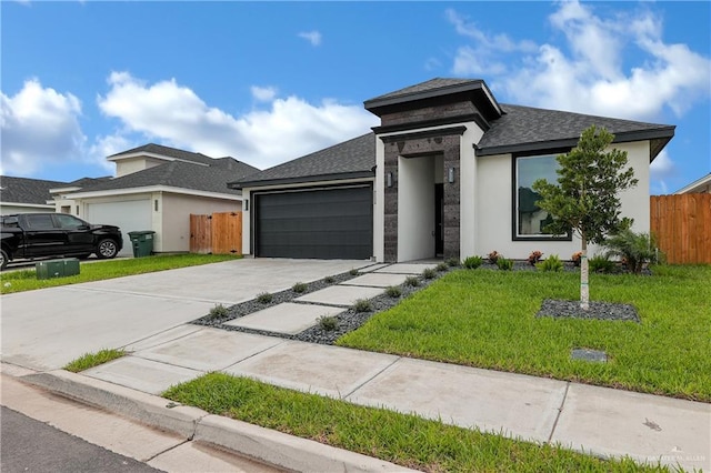 prairie-style house featuring a front yard and a garage