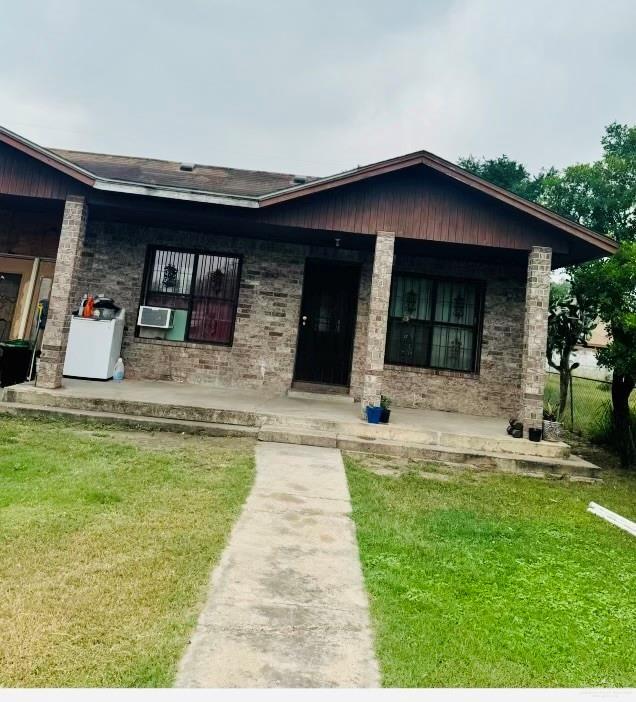3113 Daytona Ave, Mcallen, TX 78503 - view of front of home featuring a porch, a front lawn, and cooling unit