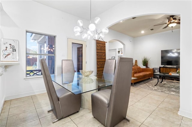 dining area with light tile patterned floors and ceiling fan with notable chandelier