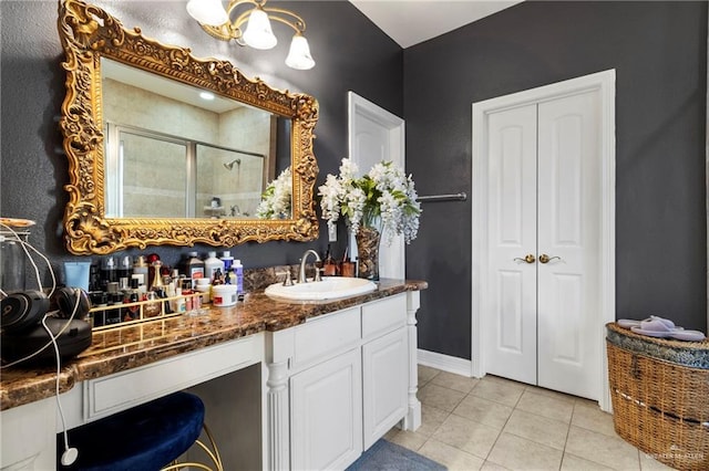 bathroom featuring tile patterned floors, an enclosed shower, and vanity