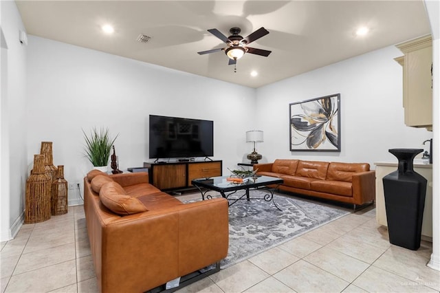 tiled living room featuring ceiling fan