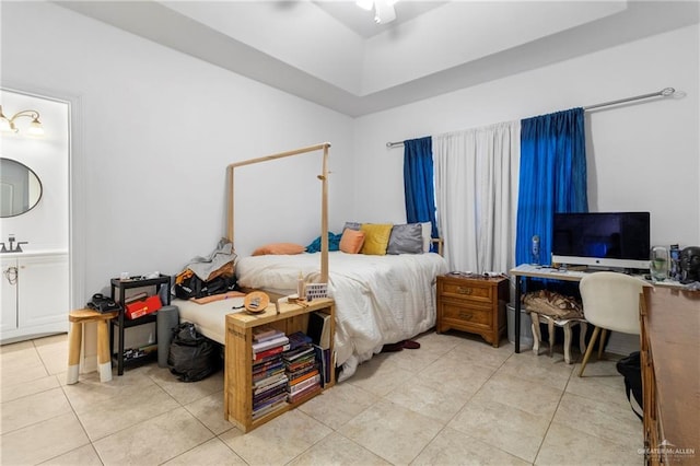 bedroom featuring ceiling fan, ensuite bath, and light tile patterned floors