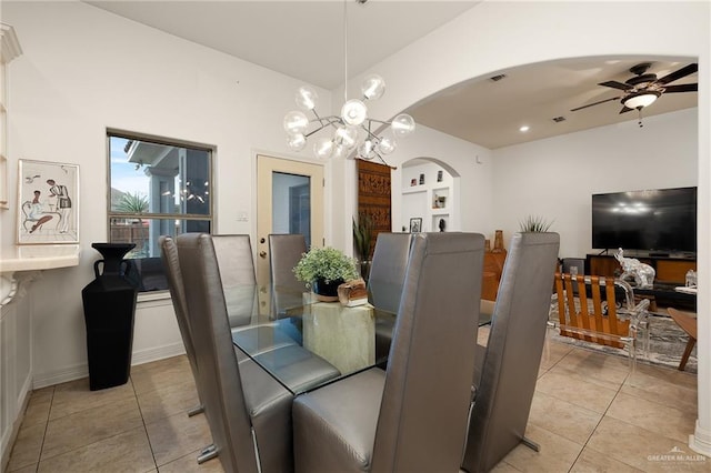 tiled dining room with built in shelves and ceiling fan with notable chandelier