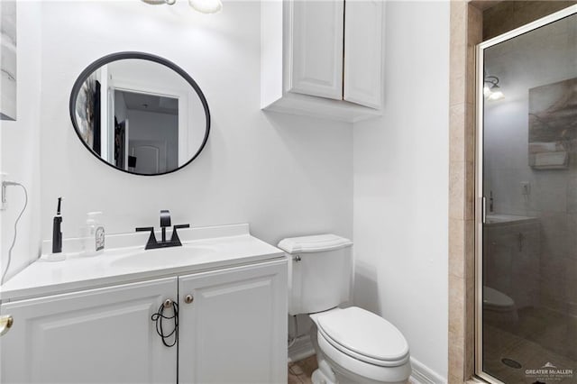 bathroom with vanity, toilet, and a shower with shower door