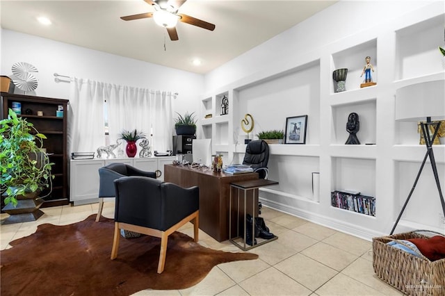 office space with light tile patterned flooring, ceiling fan, and built in shelves