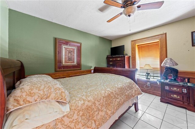 34349 Fm 732nd Hwy, San Benito, TX 78586 - bedroom with a textured ceiling and ceiling fan