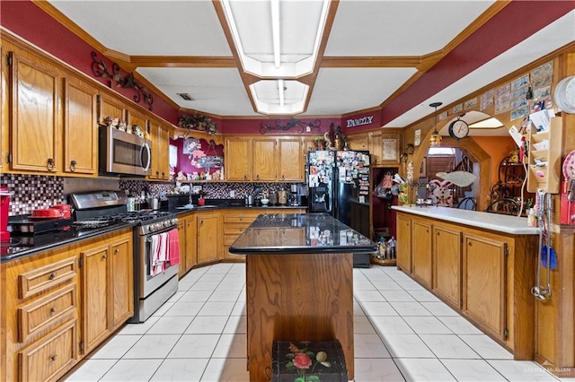 34349 Fm 732nd Hwy, San Benito, TX 78586 - kitchen with dark countertops, tasteful backsplash, appliances with stainless steel finishes, and a center island