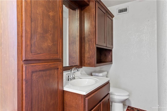 34349 Fm 732nd Hwy, San Benito, TX 78586 - bathroom featuring visible vents, toilet, and vanity