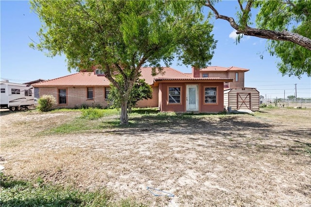 34349 Fm 732nd Hwy, San Benito, TX 78586 - view of front of property featuring a tile roof, an outbuilding, a shed, and stucco siding