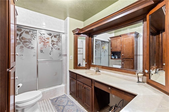 34349 Fm 732nd Hwy, San Benito, TX 78586 - bathroom with a shower with door, tile patterned flooring, toilet, vanity, and a textured ceiling