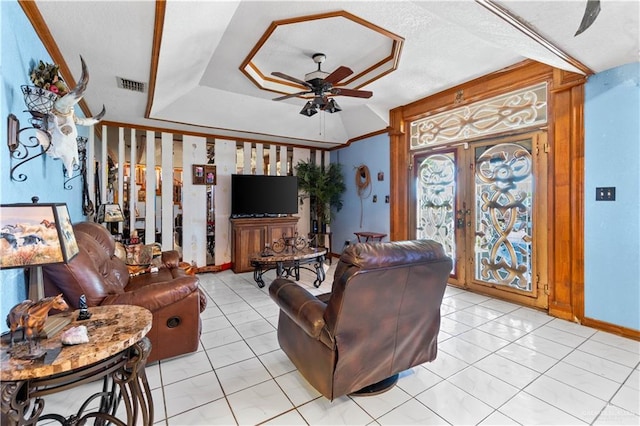 34349 Fm 732nd Hwy, San Benito, TX 78586 - living area featuring visible vents, a tray ceiling, light tile patterned floors, french doors, and a ceiling fan