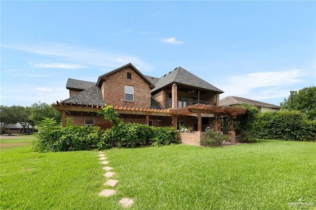 109 Palm Valley Cir, Harlingen, TX 78552 - rear view of property featuring a pergola, a yard, brick siding, and roof with shingles