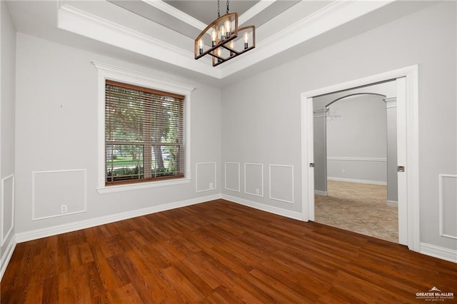 109 Palm Valley Cir, Harlingen, TX 78552 - spare room featuring ornamental molding, baseboards, a chandelier, and dark wood finished floors