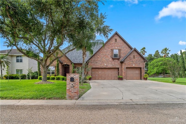 109 Palm Valley Cir, Harlingen, TX 78552 - traditional-style house featuring a front lawn, a garage, concrete driveway, and brick siding