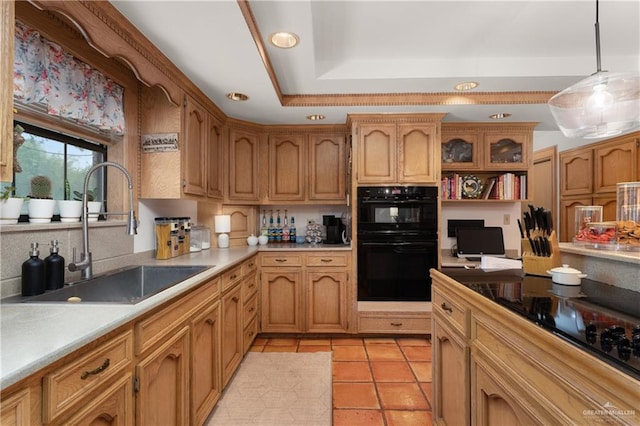 kitchen featuring sink, a raised ceiling, decorative light fixtures, light tile patterned floors, and black appliances