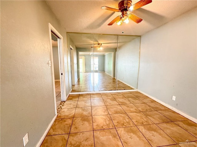 interior space featuring ceiling fan and a textured ceiling