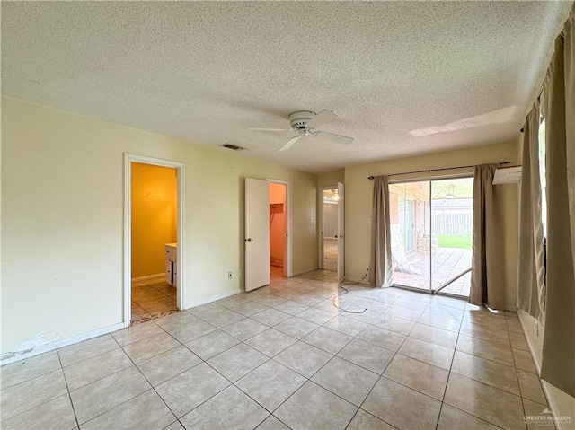 unfurnished room with light tile patterned floors, a textured ceiling, and ceiling fan