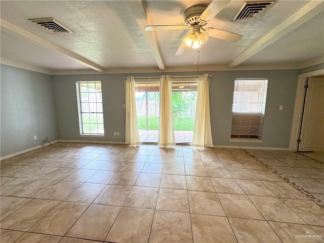 spare room with beam ceiling, light tile patterned flooring, ceiling fan, and a textured ceiling