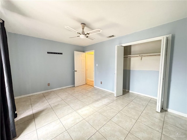 unfurnished bedroom featuring light tile patterned floors, a closet, and ceiling fan