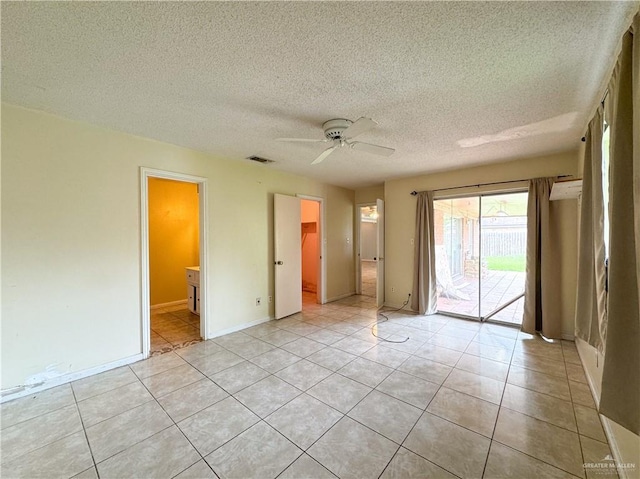 tiled spare room with a textured ceiling and ceiling fan