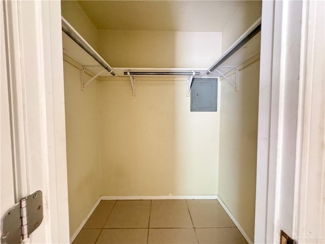 walk in closet featuring tile patterned flooring and electric panel