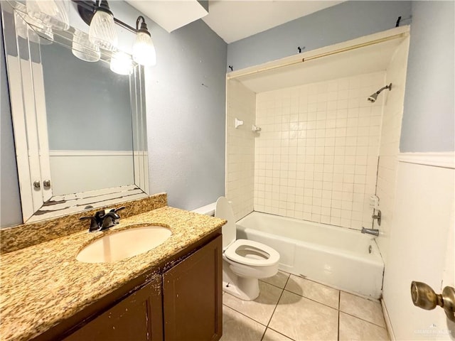 full bathroom featuring tiled shower / bath combo, vanity, tile patterned floors, and toilet