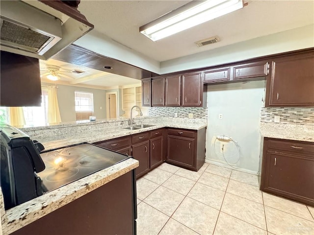 kitchen with tasteful backsplash, sink, light tile patterned floors, ceiling fan, and kitchen peninsula