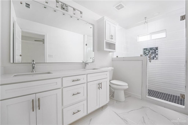 bathroom featuring toilet, vanity, and an enclosed shower