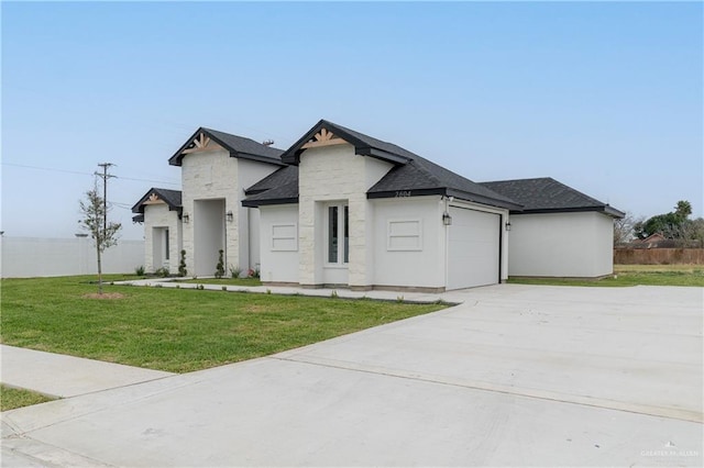 view of front of home with a garage, concrete driveway, a front yard, and fence