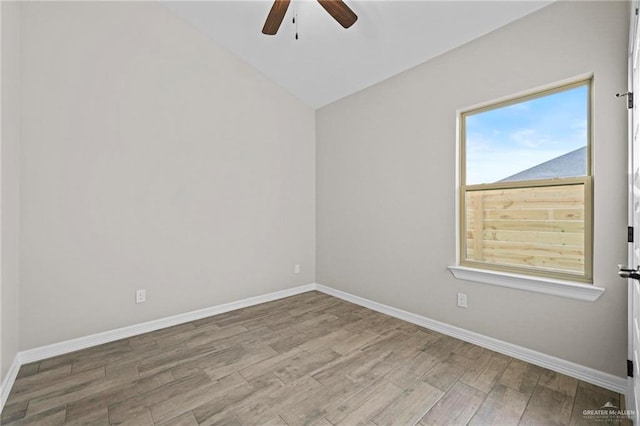 empty room featuring ceiling fan, vaulted ceiling, and light hardwood / wood-style flooring