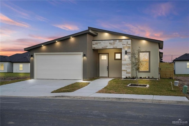 contemporary house featuring a garage and a yard