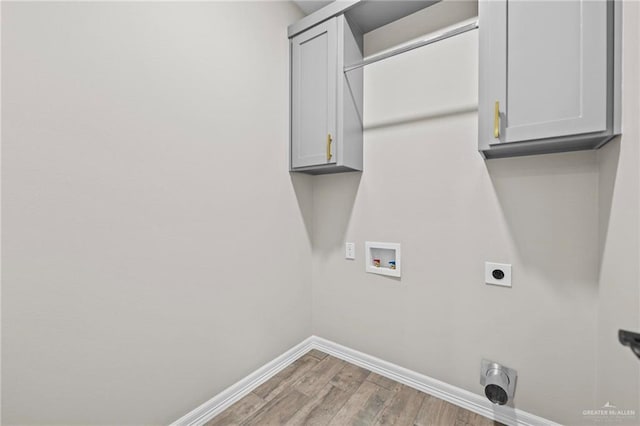 washroom with cabinets, washer hookup, hookup for an electric dryer, and hardwood / wood-style floors