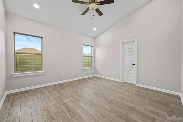 empty room featuring vaulted ceiling, ceiling fan, and light hardwood / wood-style floors