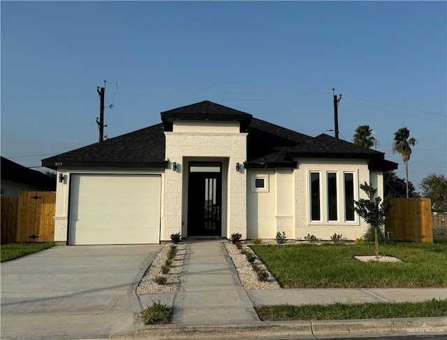 view of front of house featuring a front lawn and a garage